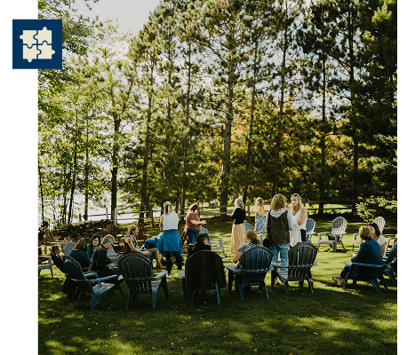 Retreat participants mingling out on the lawn at Sugar Lake Lodge