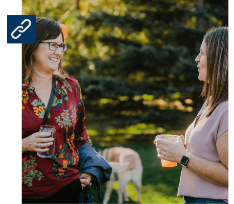 Two retreat participants smiling and talking