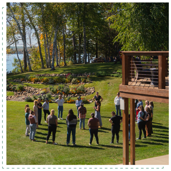 Team standing in a circle and participating in outdoor activity