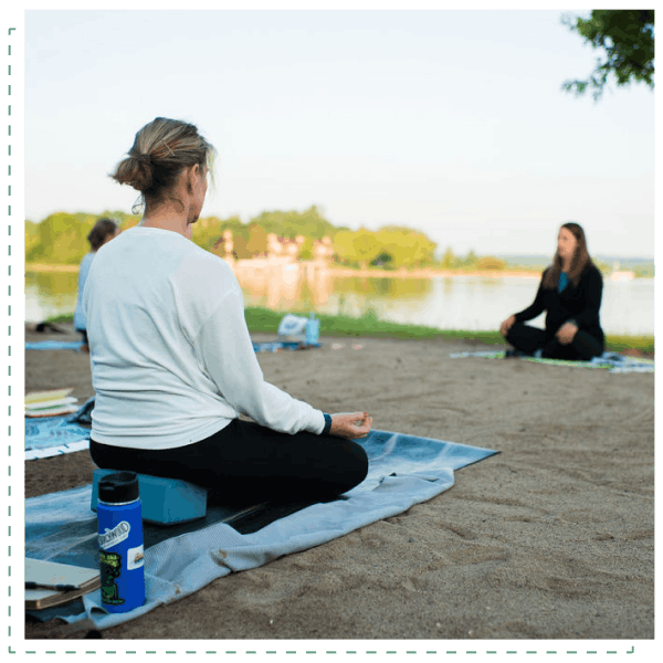 Women doing yoga on a beach