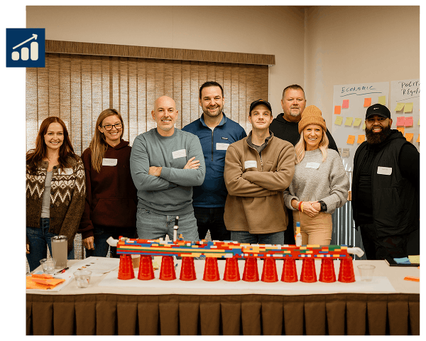 Leading Business-min Team members smiling for a photo with their completed project