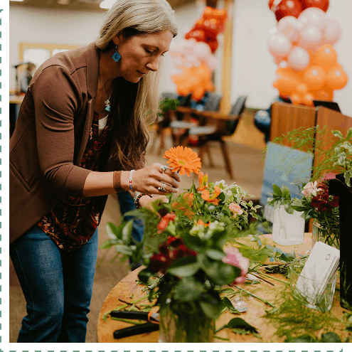 Retreat participant arranging flowers in a vase