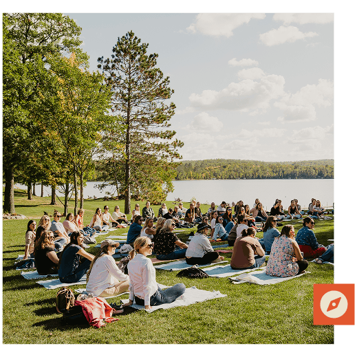 Retreat participants in a wellness activity outside on the lodge lawn
